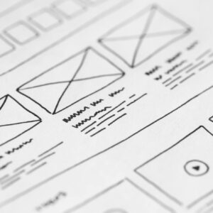 Detailed close-up of a hand-drawn wireframe design on paper for a UX project.